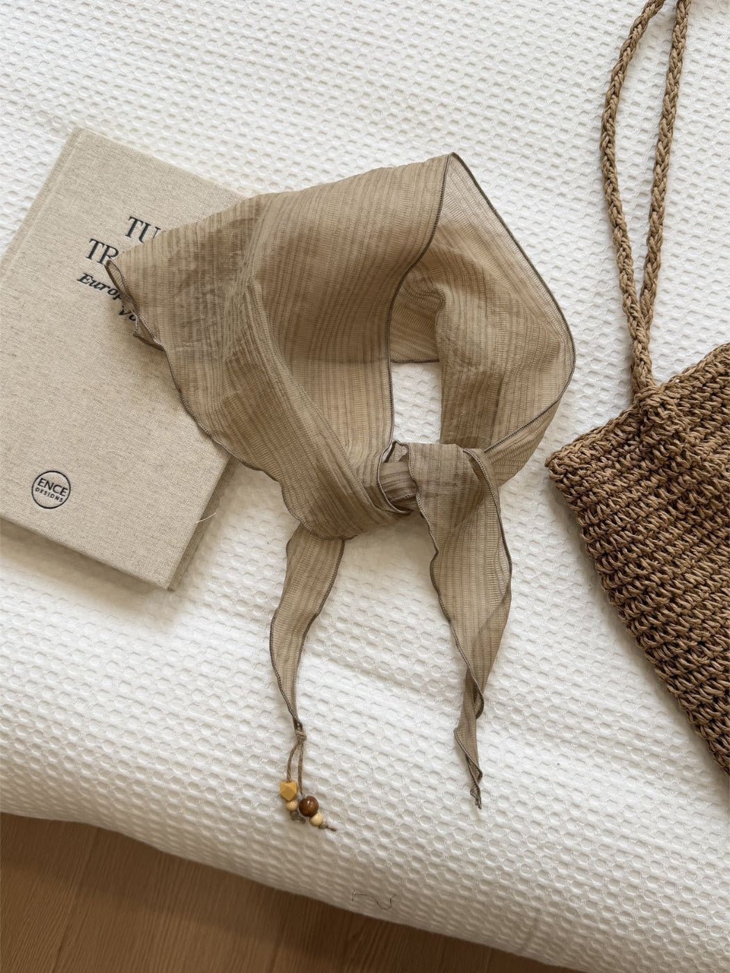 Triangle bandana scarf folded neatly on a wooden surface