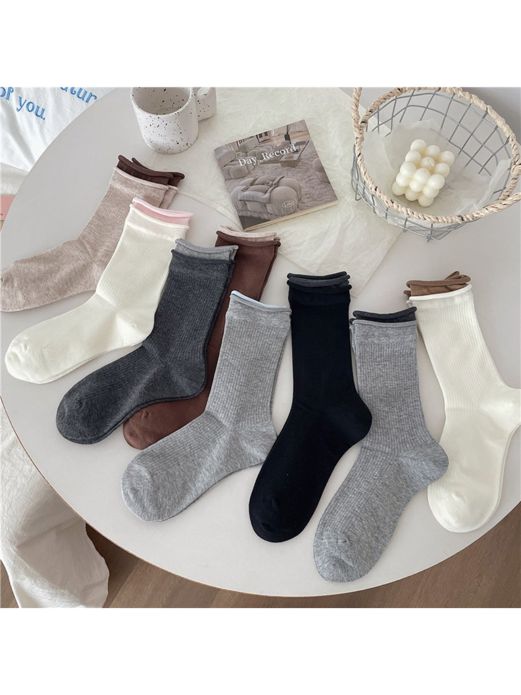 Pair of Rufia casual roll cuff crew socks in light gray displayed flat