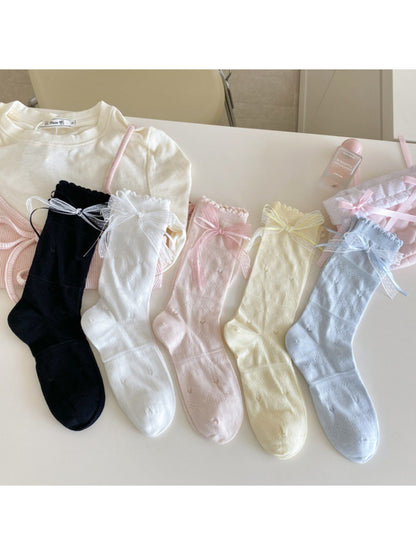 Pair of Rufia Romantic Ribbon Trim Socks laid flat highlighting soft fabric and trim
