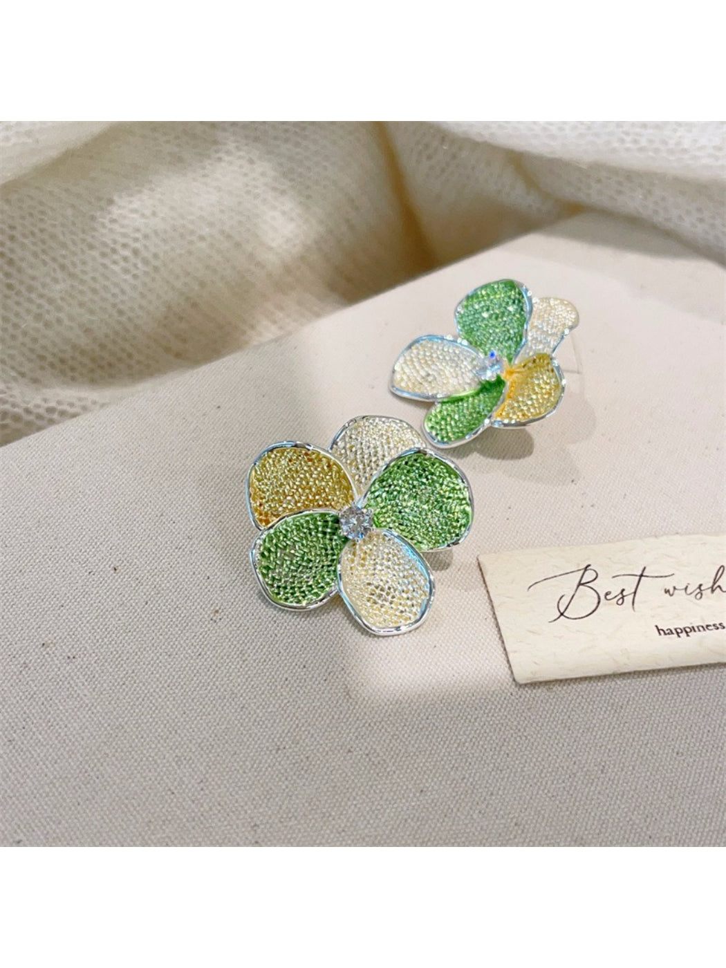 Earwish floral cluster earrings in a jewelry box with soft lighting
