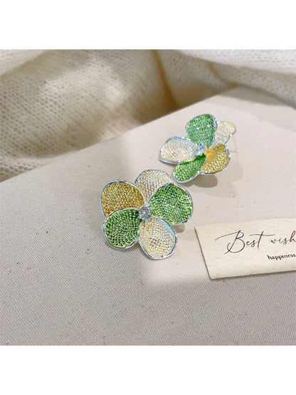Earwish floral cluster earrings in a jewelry box with soft lighting