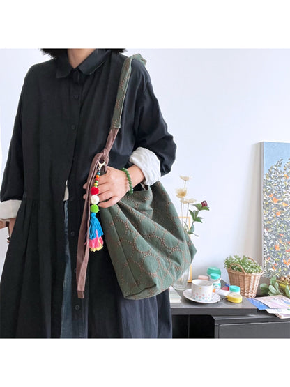 Cosbai tote bag worn over shoulder demonstrating size and fit on model