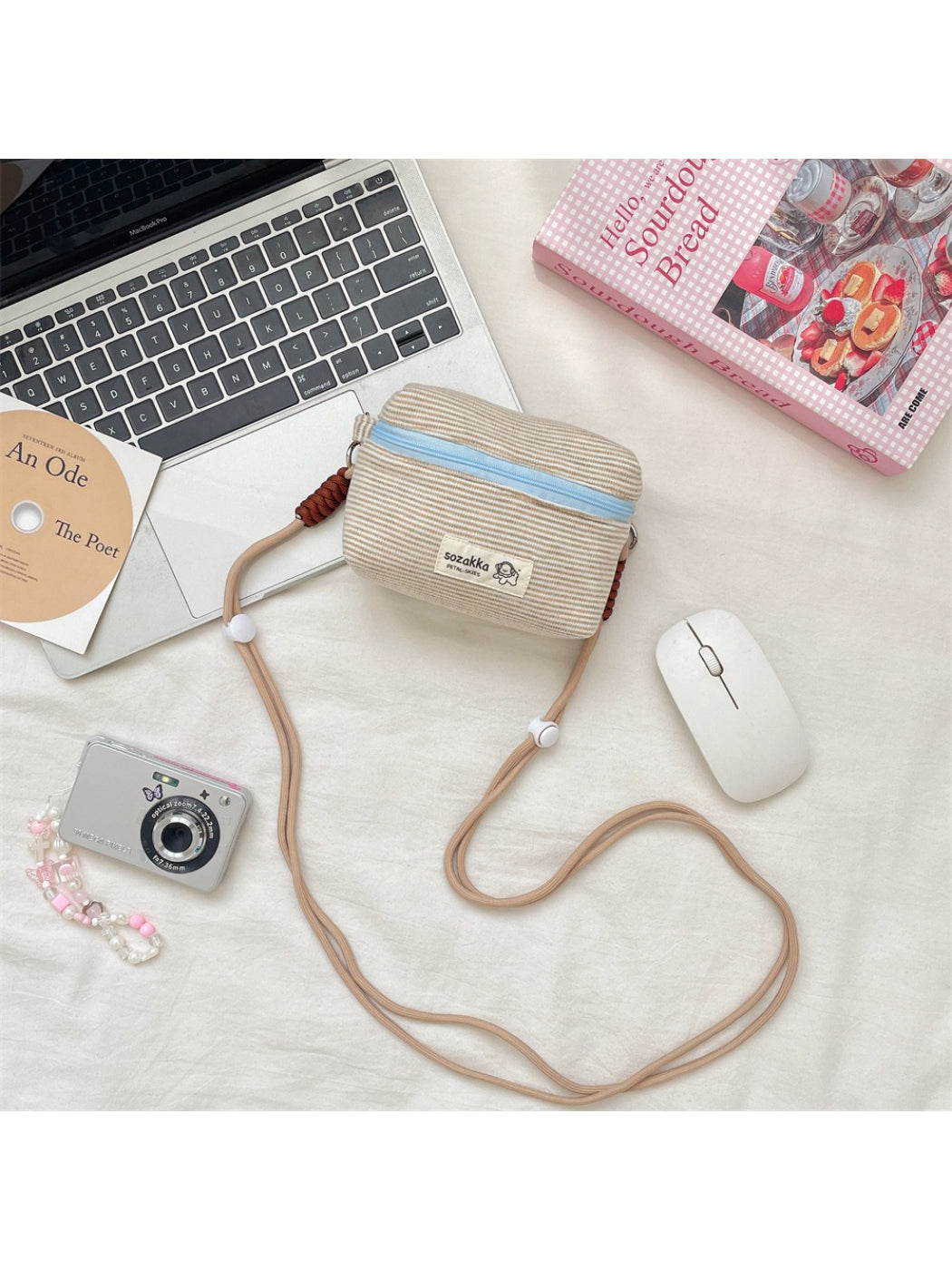 Cosbai striped mini crossbody pouch worn across the body on a model