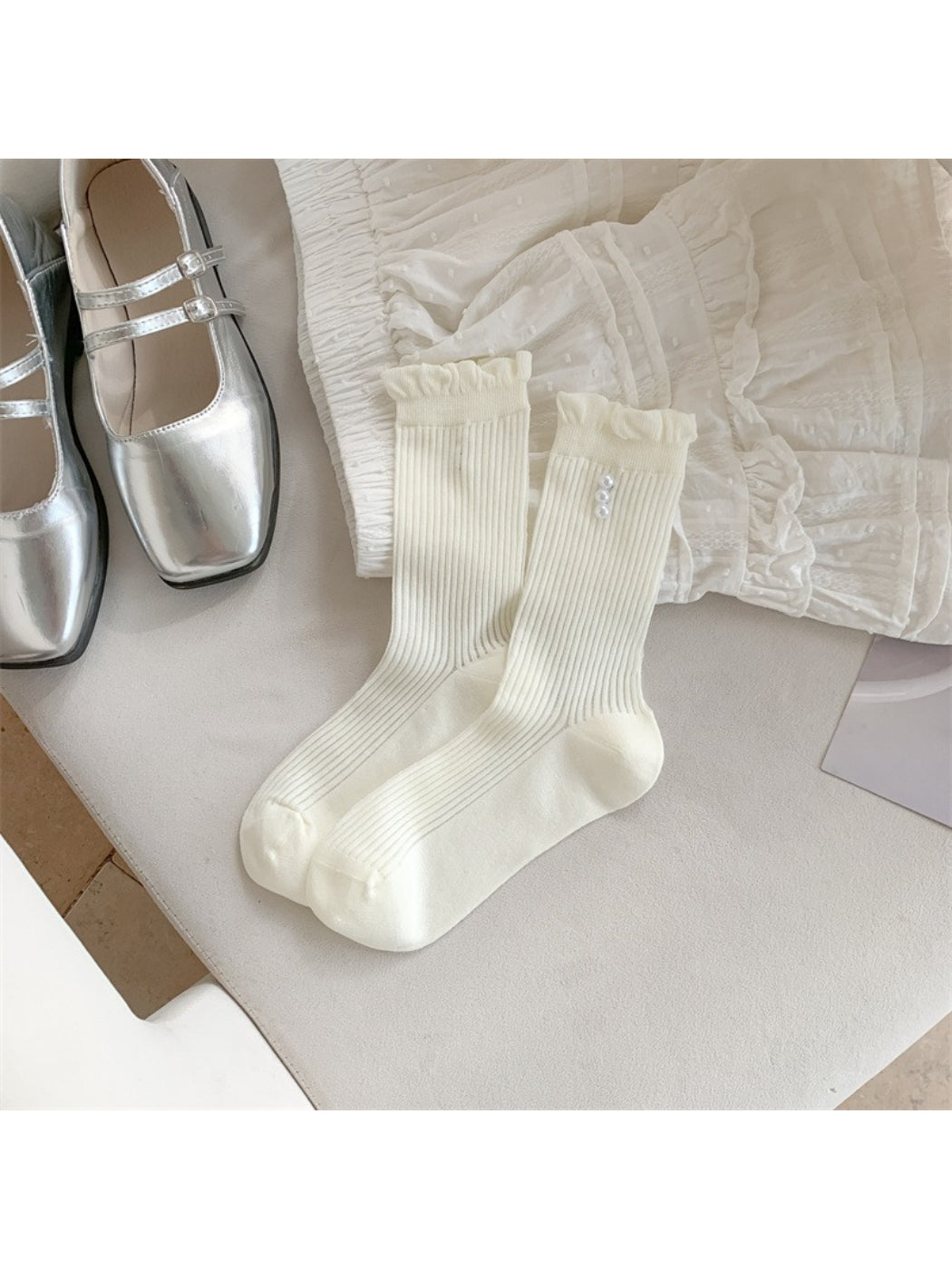 Model wearing Rufia soft rib crew socks with delicate trim detail