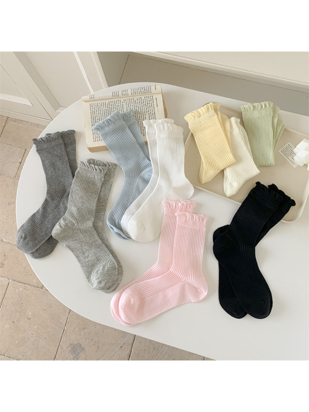 Pair of Rufia Everyday Ruffle Cuff Crew Socks in soft pastel pink displayed flat