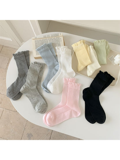 Pair of Rufia Everyday Ruffle Cuff Crew Socks in soft pastel pink displayed flat