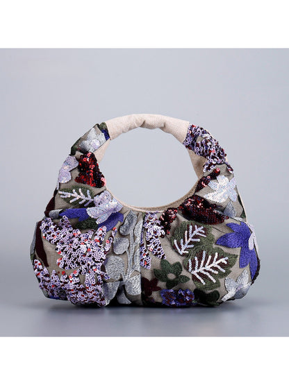 Detailed shot of ruched handle and floral sequin embellishments on Cosbai bag