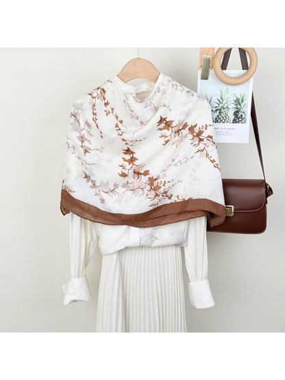 Scarvii leaf print wrap scarf displayed flat showing green and beige leaf pattern