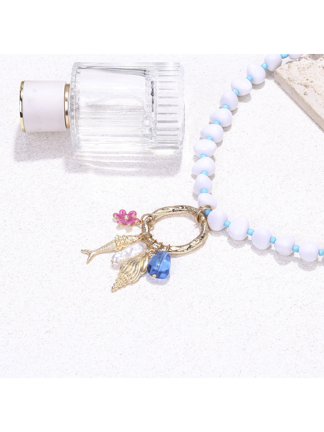 Neckit beaded necklace with ring charm detail worn on a model's neck