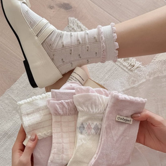 Pair of Rufia soft knit crew socks with ruffle trim in light beige