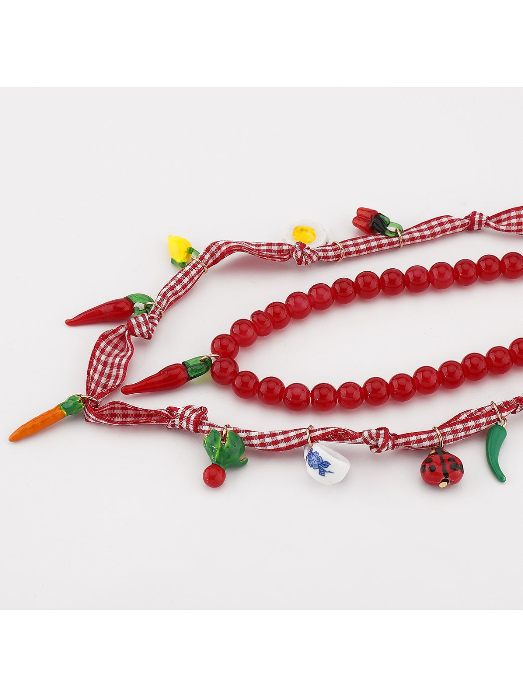 Model wearing the Neckit Playful Food Charm Necklace showcasing vibrant food charms