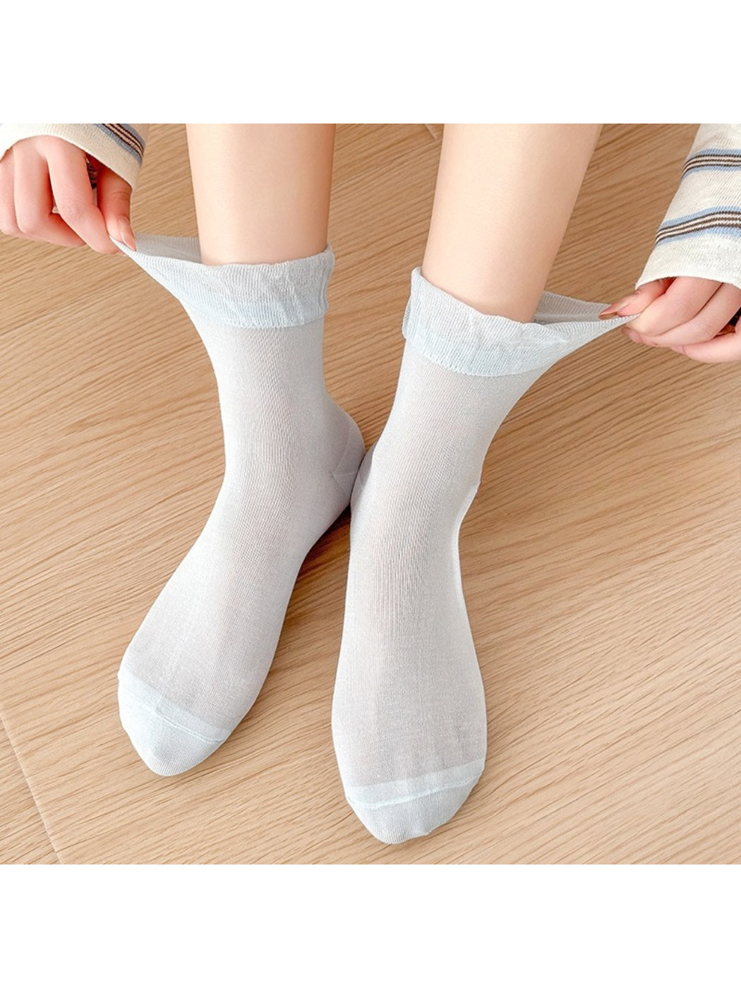 Model wearing Rufia ruched ankle socks with bow charm and white shoes