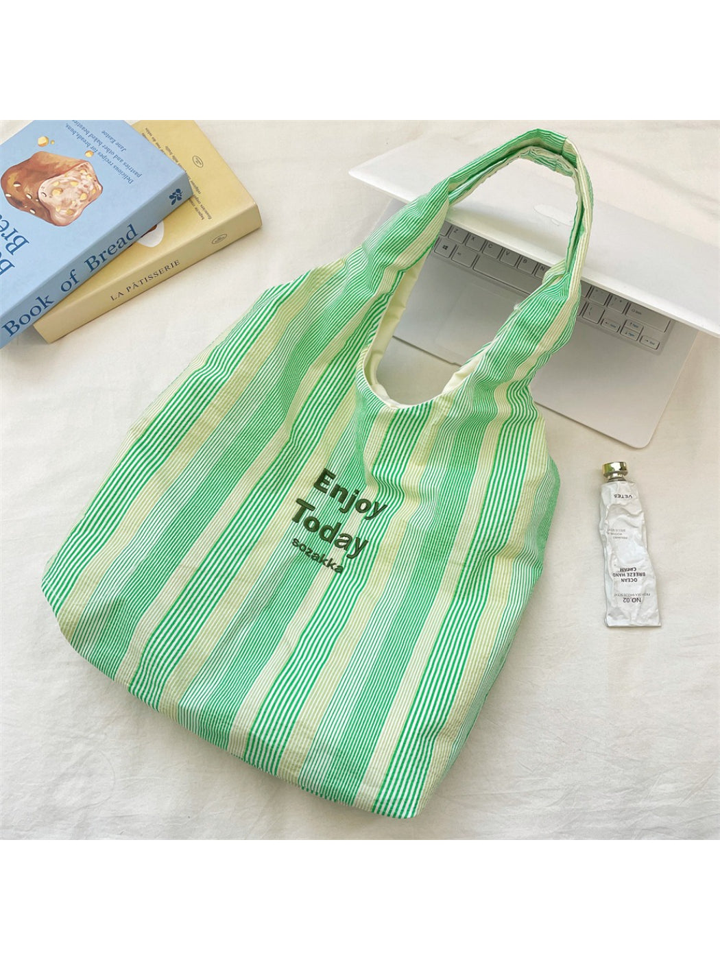 Cosbai Enjoy Today tote bag displayed hanging on a hook with visible stripes and handles