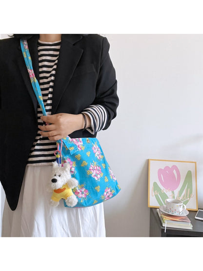 Close-up of floral pattern on Cosbai Painterly Bloom shoulder bag with dog charm