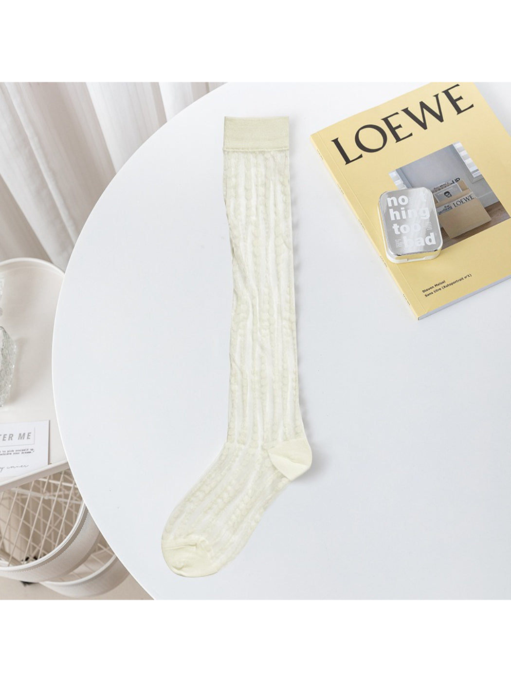 Model wearing Rufia lace floral knee high socks with black shoes