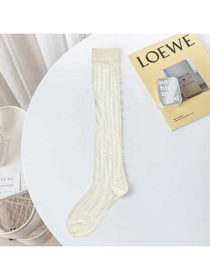 Model wearing Rufia lace floral knee high socks with black shoes