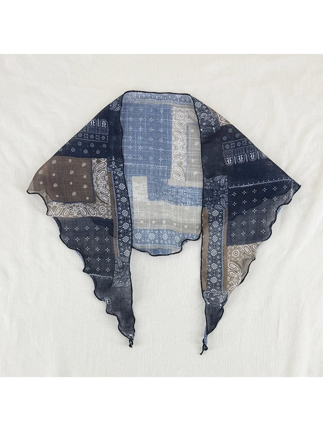 Scarvii sheer bandana print scarf folded to display triangular shape and pattern