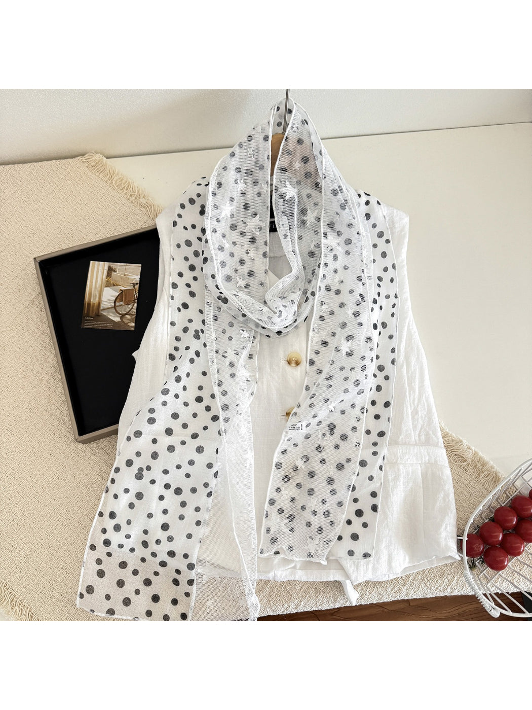 Scarvii sheer star print scarf draped over a chair highlighting fabric texture
