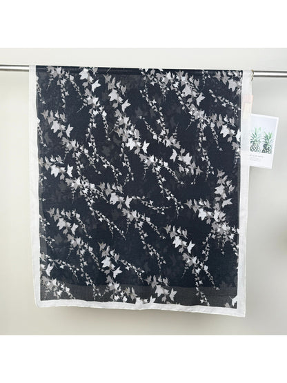 Scarvii leaf print wrap scarf styled as a head wrap on model