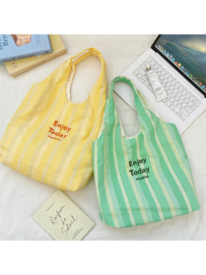 Close-up of Cosbai Enjoy Today tote bag showing black handles and striped fabric detail