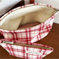 Close-up of Cosbai red plaid cosmetic bag showing fabric pattern and texture