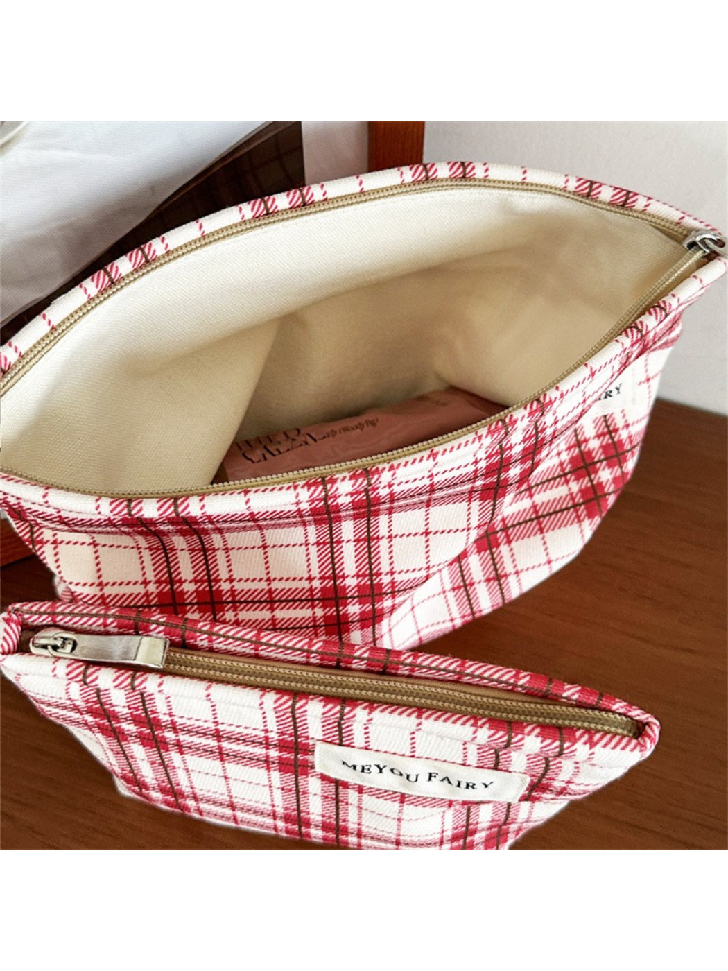 Close-up of Cosbai red plaid cosmetic bag showing fabric pattern and texture