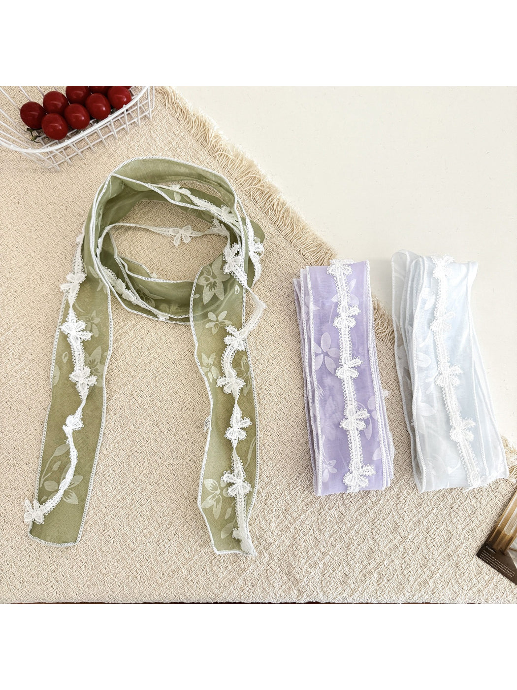 Sheer floral lace trim skinny scarf in soft pastel colors displayed flat
