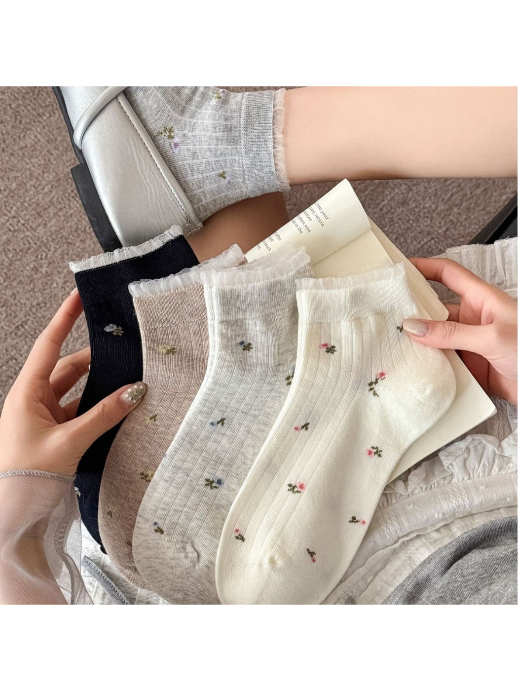 Pair of Rufia soft floral lace trim ankle socks in white displayed flat