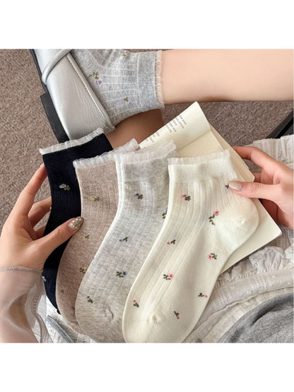 Pair of Rufia soft floral lace trim ankle socks in white displayed flat