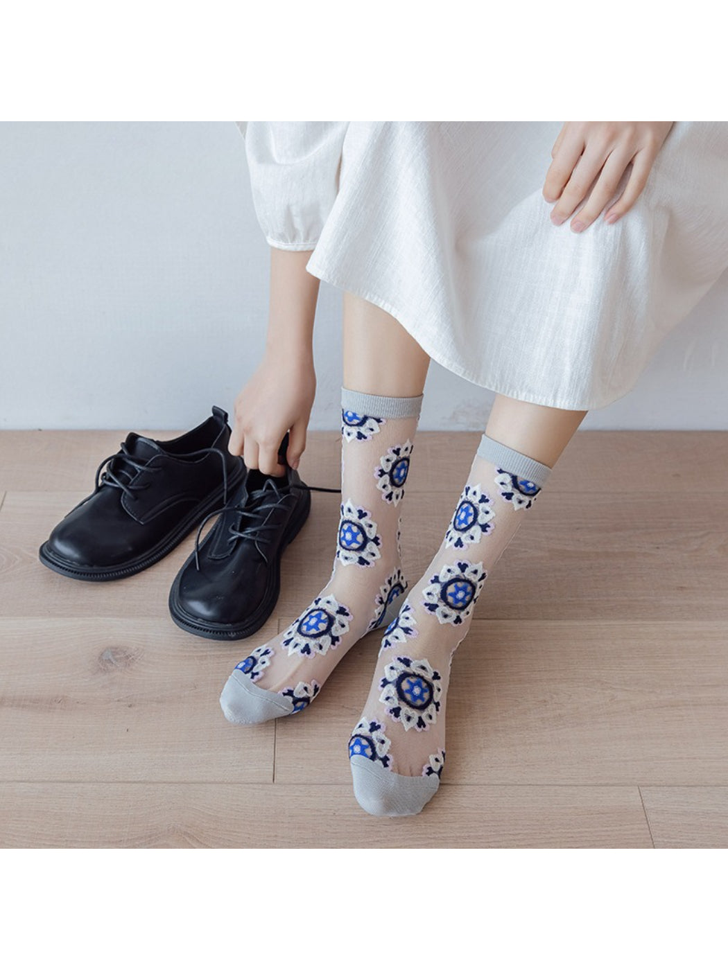 Rufia sheer blossom pattern crew socks displayed flat showing floral design