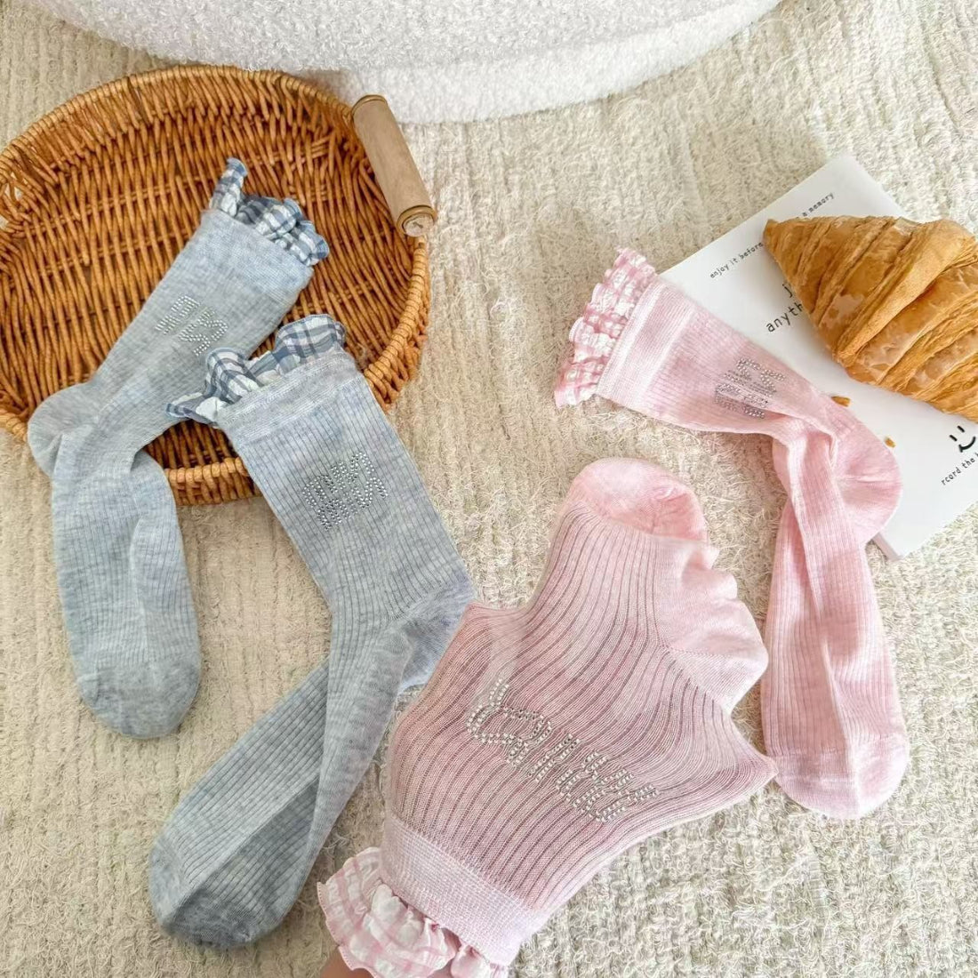 Pair of Rufia ruffle pastel mid-calf socks laid flat showing soft ruffle trim