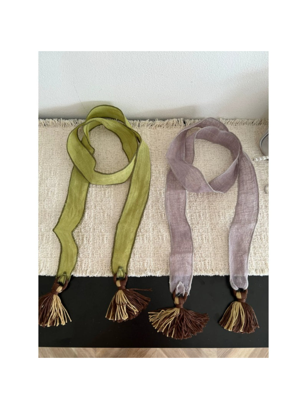 Scarvii boho skinny scarf with tassel trim in neutral tones laid flat