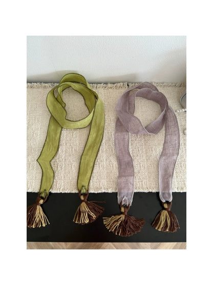 Scarvii boho skinny scarf with tassel trim in neutral tones laid flat