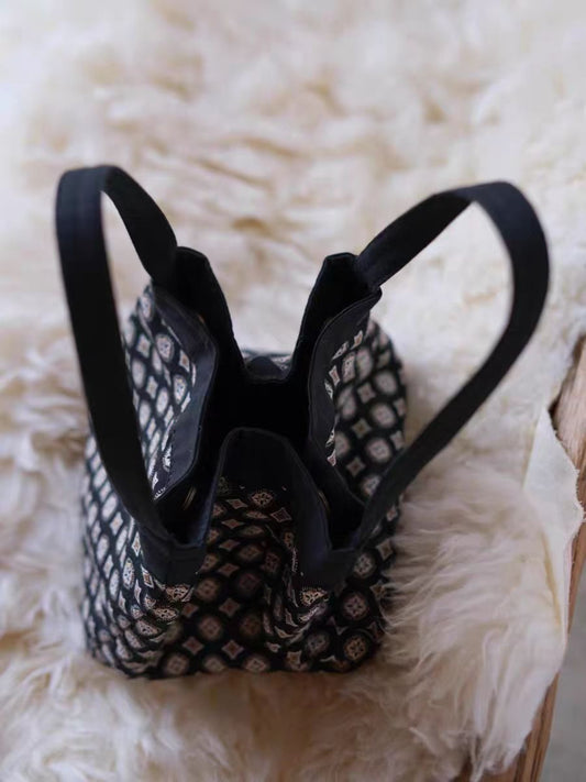 Close-up of Cosbai black tile pattern tote bag showing textured design