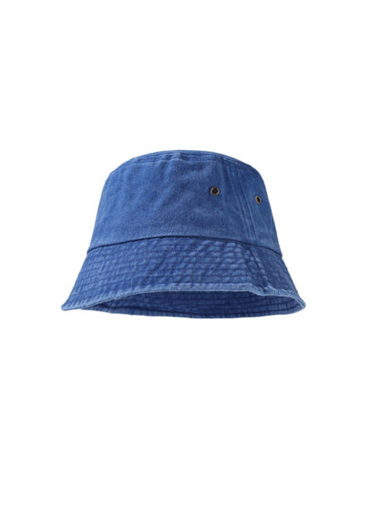 Model adjusting Haila bucket hat while smiling