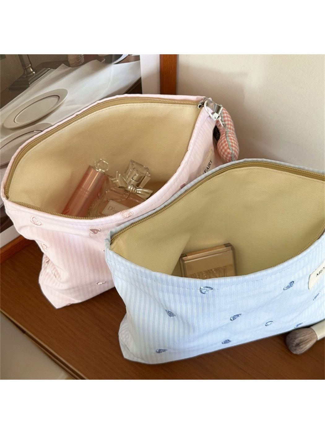Cosbai soft cosmetic bag with pink hearts displayed with cosmetics
