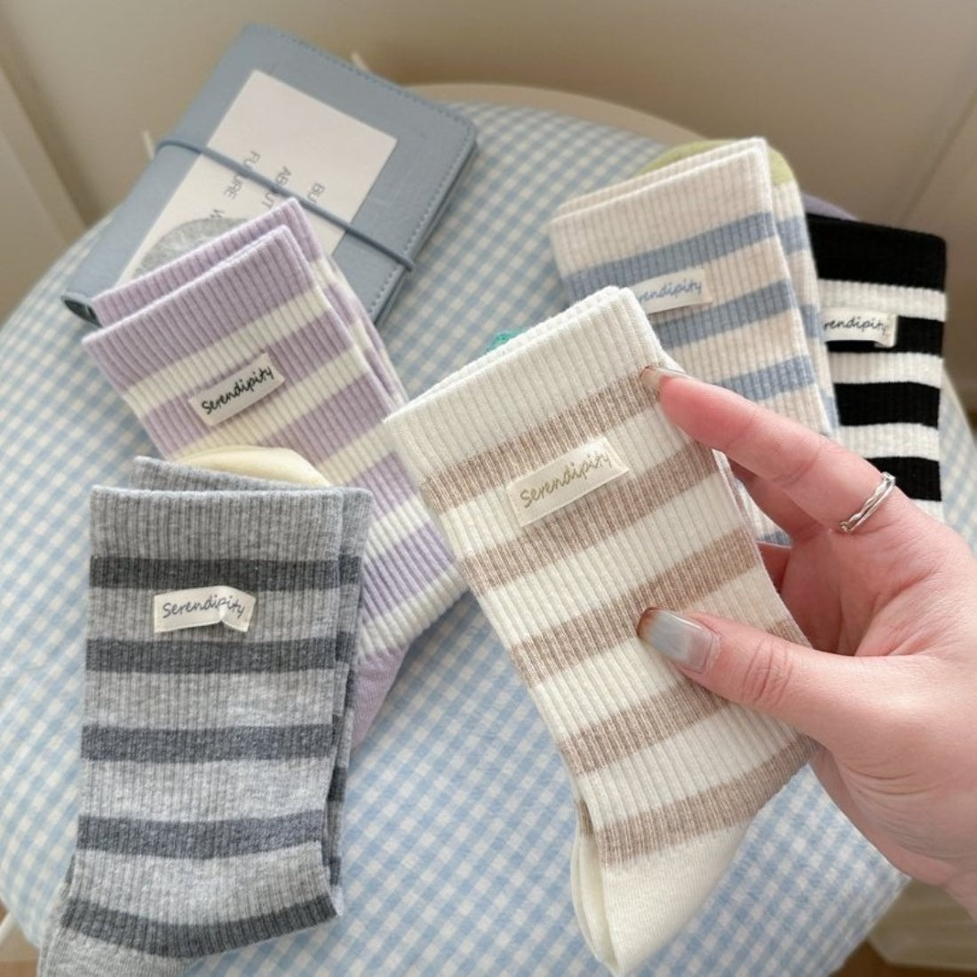 Pair of Rufia soft ribbed stripe crew socks in beige and white laid flat