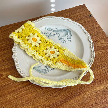 Side angle of crochet flower hairband showing flower layering and colors