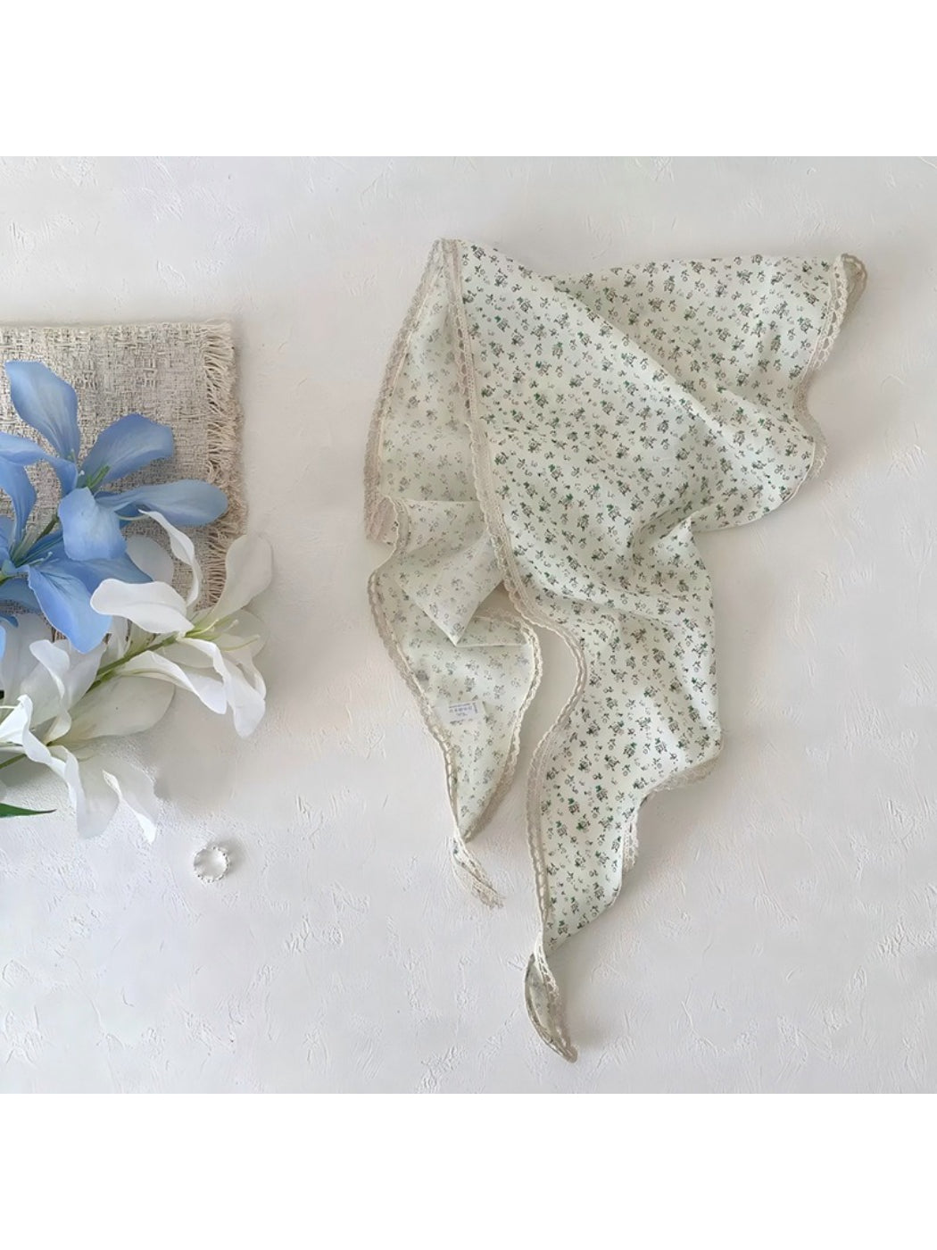 Scarvii ditsy floral lace tie headscarf tied around a ponytail on a model