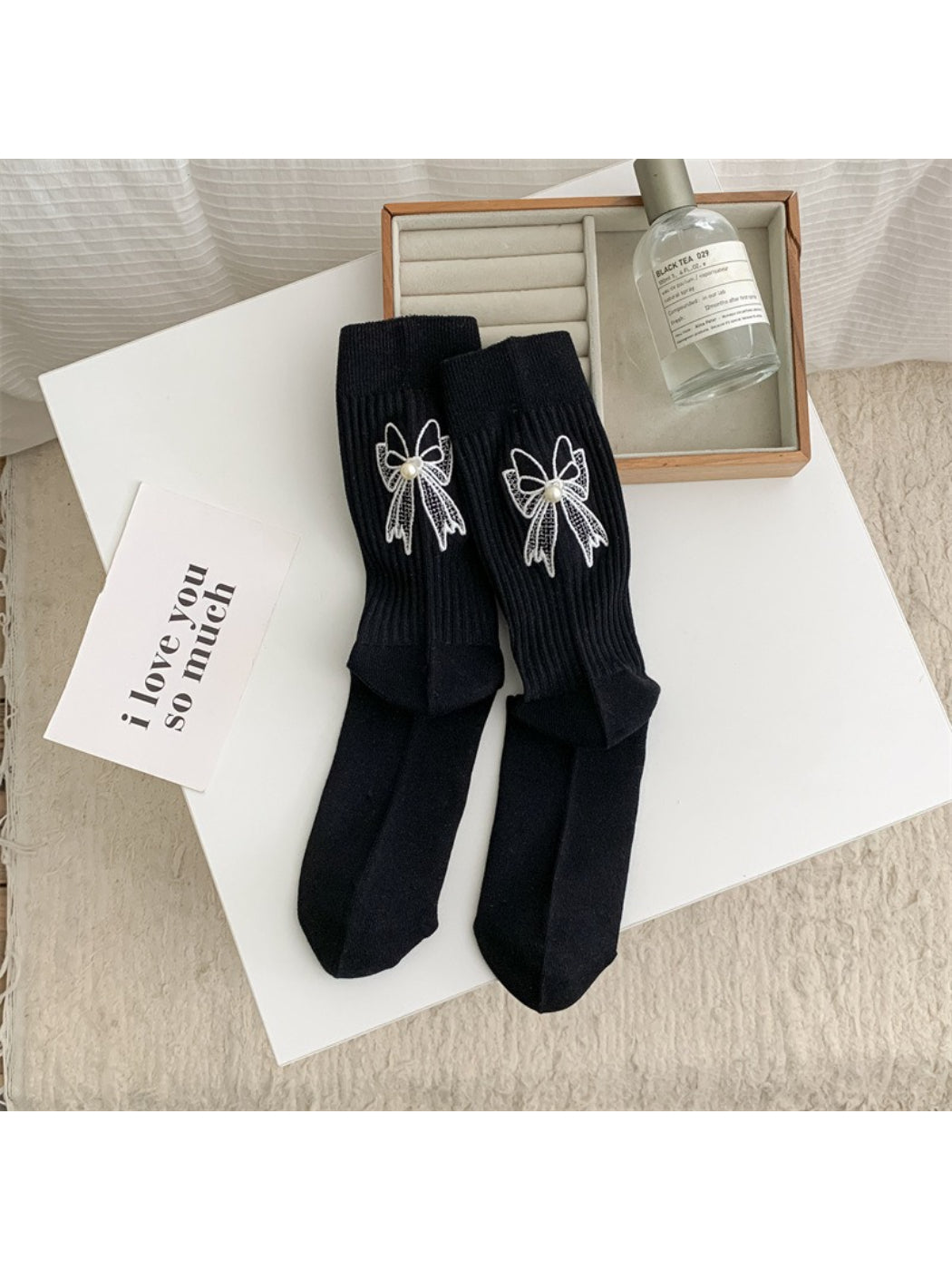 Rufia crew socks in light beige displayed flat showing full length and bow