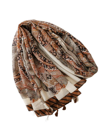 Boho paisley tassel wrap scarf draped over shoulders on model
