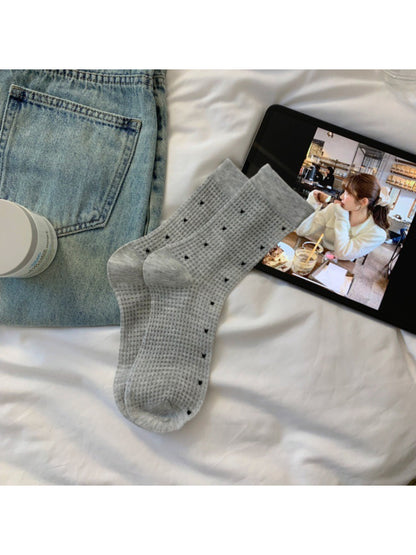 Close-up of sock cuff and waffle knit pattern on Rufia Waffle Dot Crew Socks