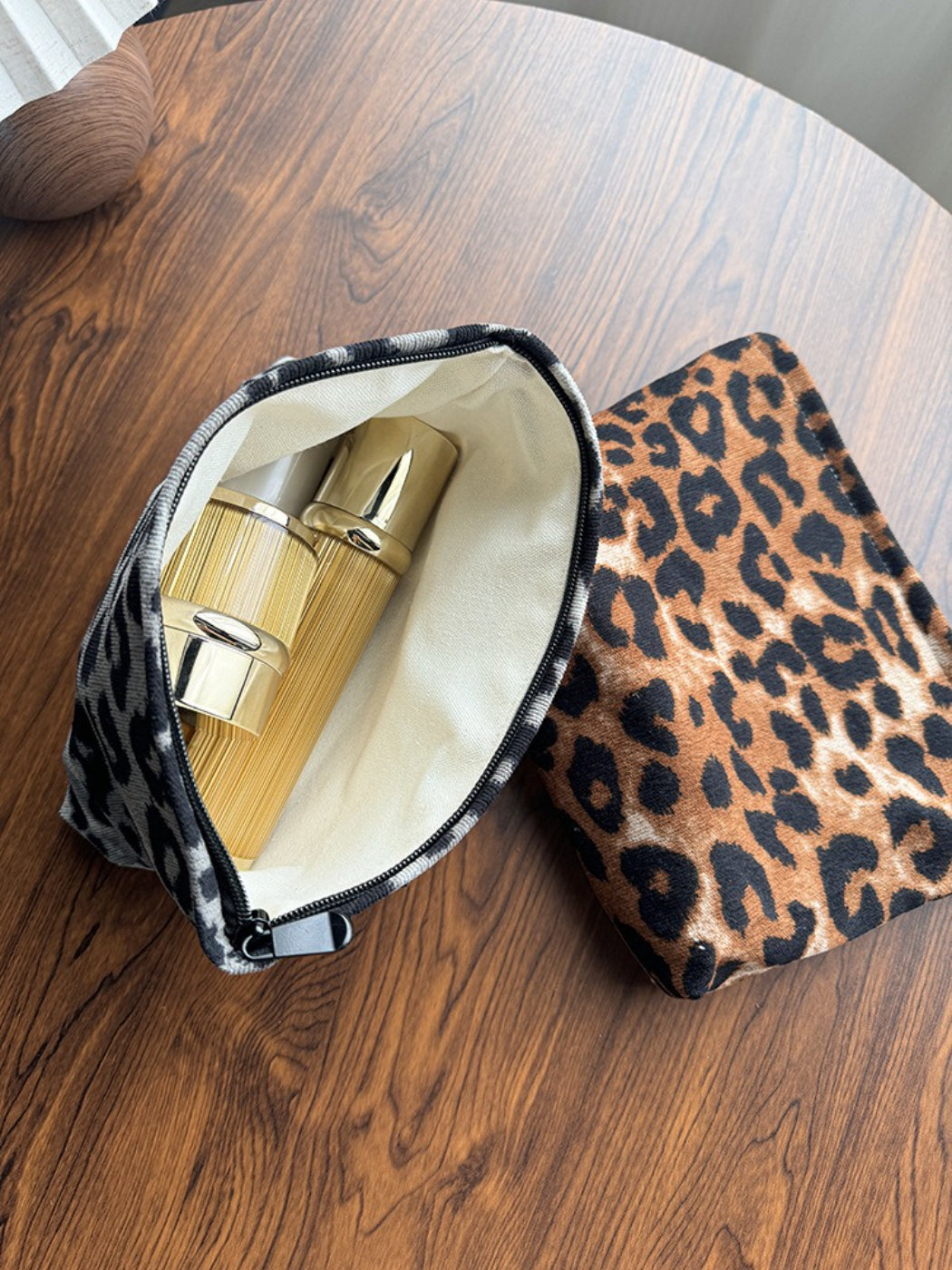 Cosbai leopard print Travel Pouch held in hand showing size and scale