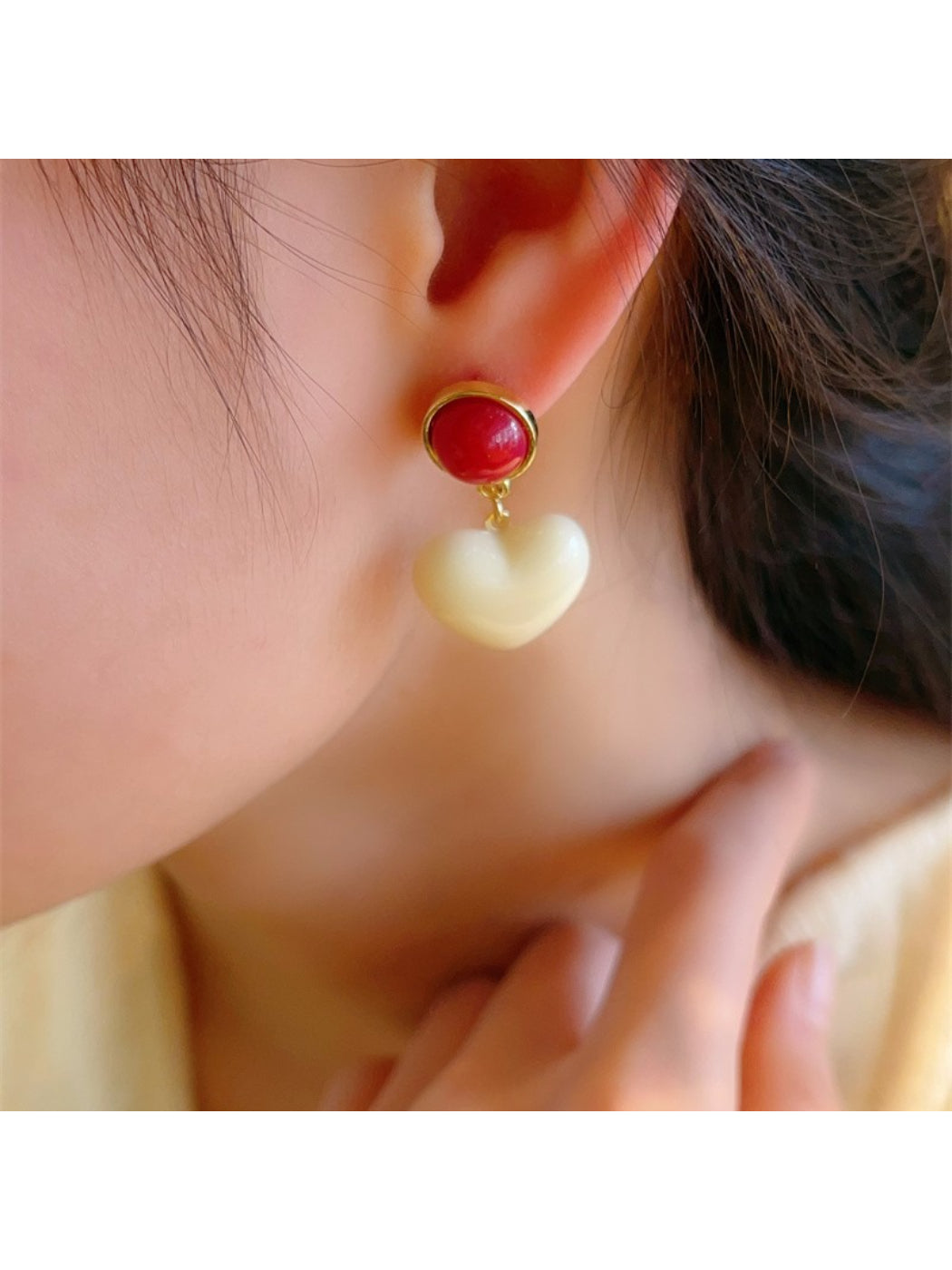 Model wearing Earwish Color Pop Heart Drop Earrings with casual outfit