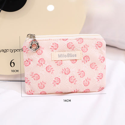 Cosbai floral coin purse with multicolored floral print on light background