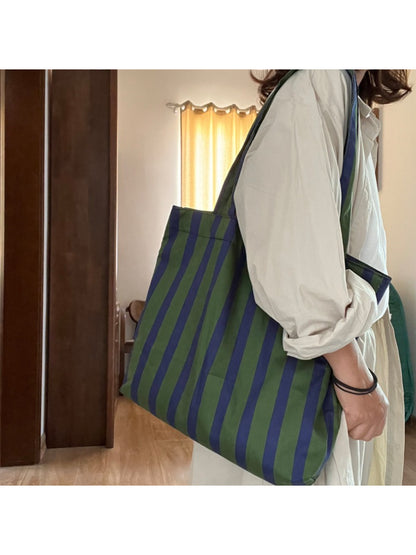 Side view of Cosbai green stripe shoulder tote bag showing depth and strap