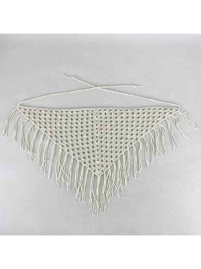 Flat lay of the crochet bandana with tassels spread out on a white background