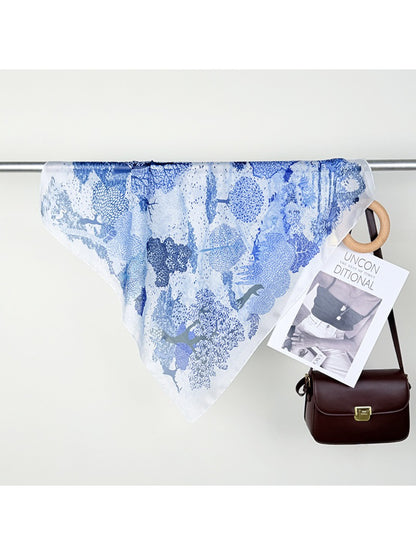 Scarvii scarf draped over shoulder highlighting the intricate forest border pattern