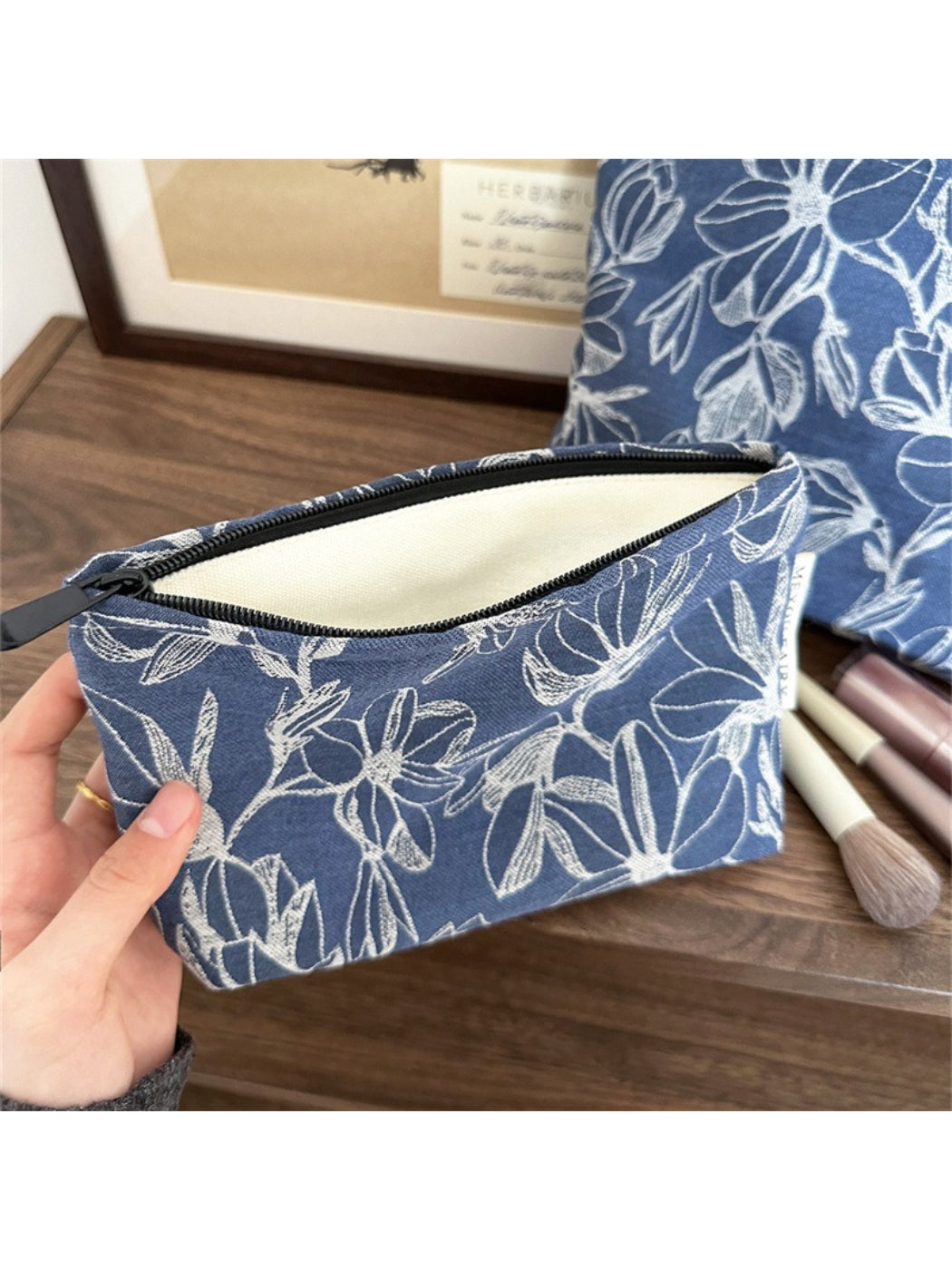 Cosbai floral cosmetic bag on a white surface with lighting