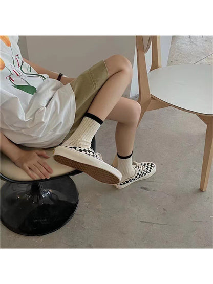 Model wearing Rufia mesh color block mid-calf socks styled with casual footwear